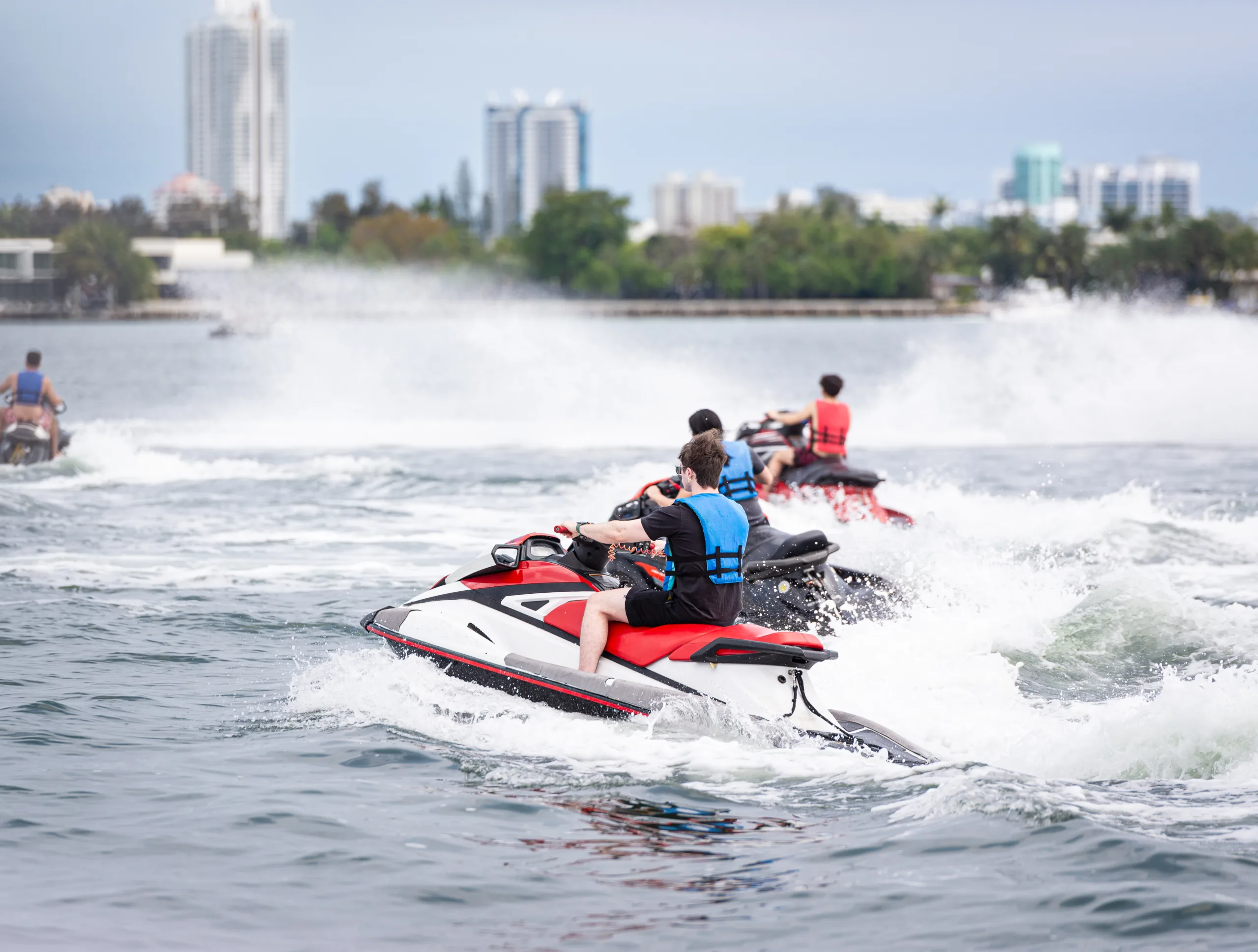 Tourists enjoying a jet ski rental from Jet Skis Rentals of Miami, a popular activity for fun in Miami Beach.